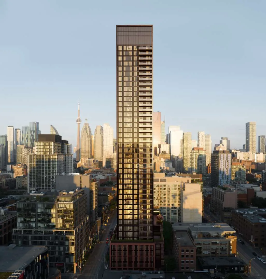 Rendering of the Allure tower at sunset, its bronze facade rising above the King Street East rooftops